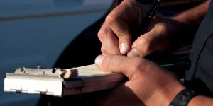 Officer Signing Traffic Ticket - Traffic ticket help Missouri